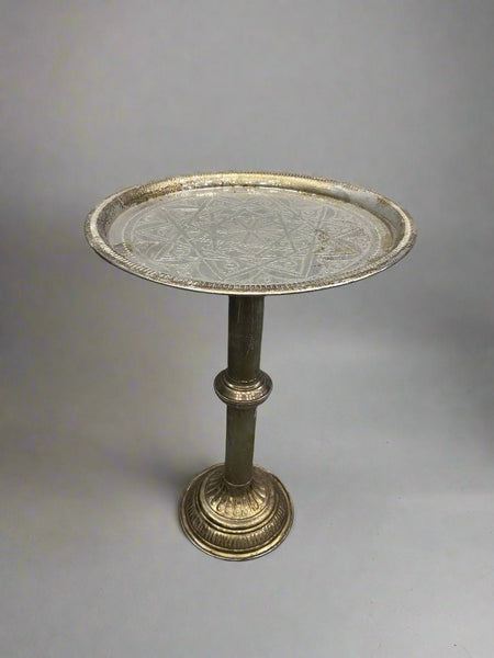 Faded brass pedestal tea table with an etched arabesque design.