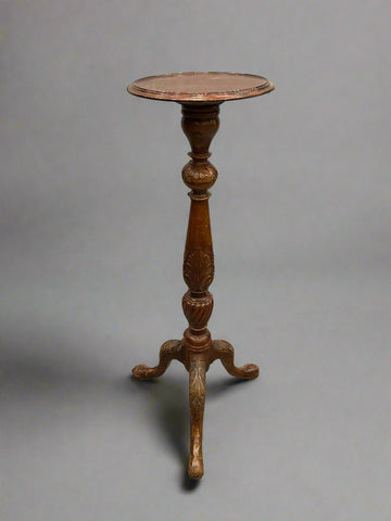 Victorian carved torchiere with a central carved pillar and tripod legs.