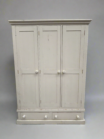 Rustic cream wardrobe armoire with three doors and two drawers.