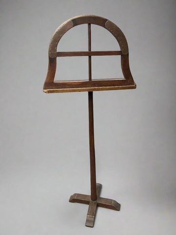 Antique, floor-standing, wooden magazine rack with an arched top and studded copper detailing.