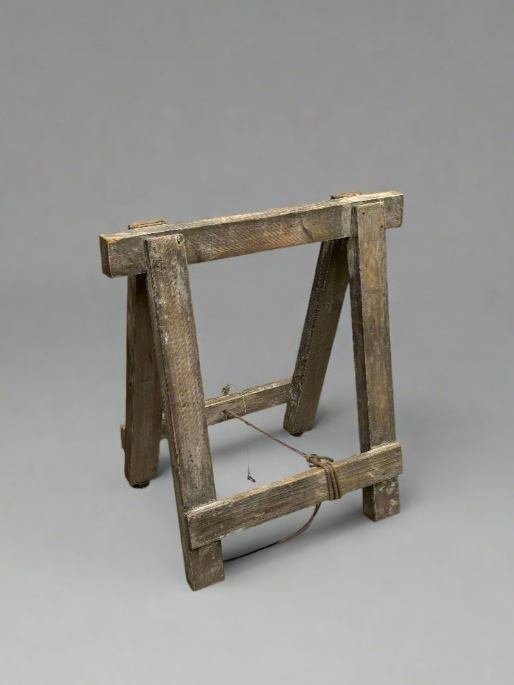 Rustic wooden trestle stand.
