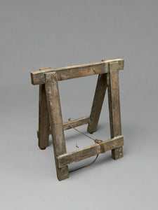 Rustic wooden trestle stand.