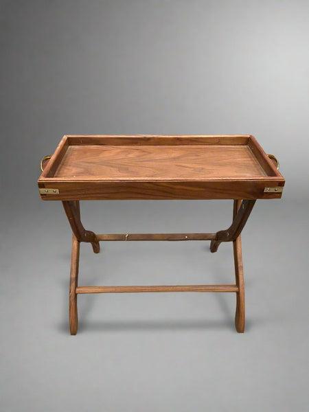 Antique wood and leather butler's serving stand with brass handles.