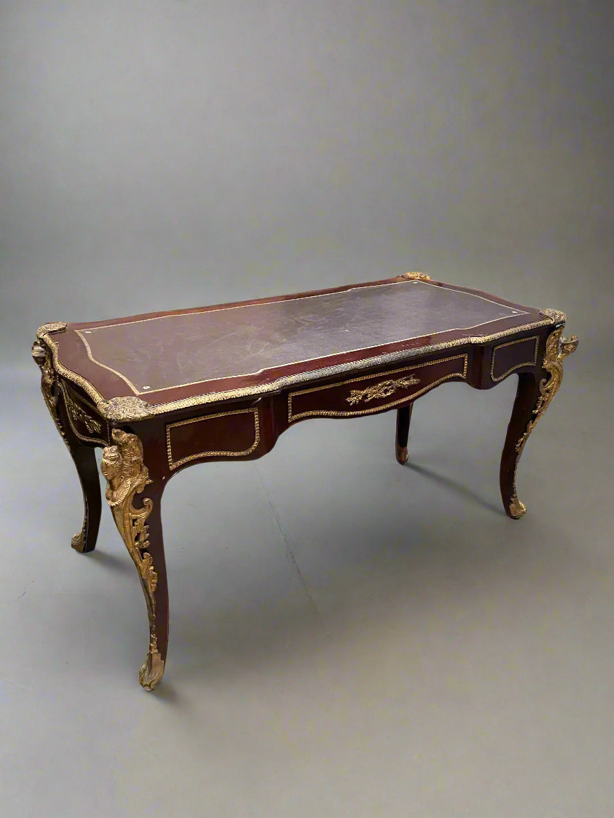 French Louis XVI style writing desk, circa 1880s. An ornate, baroque, presidential style piece with ormolu decorated details.