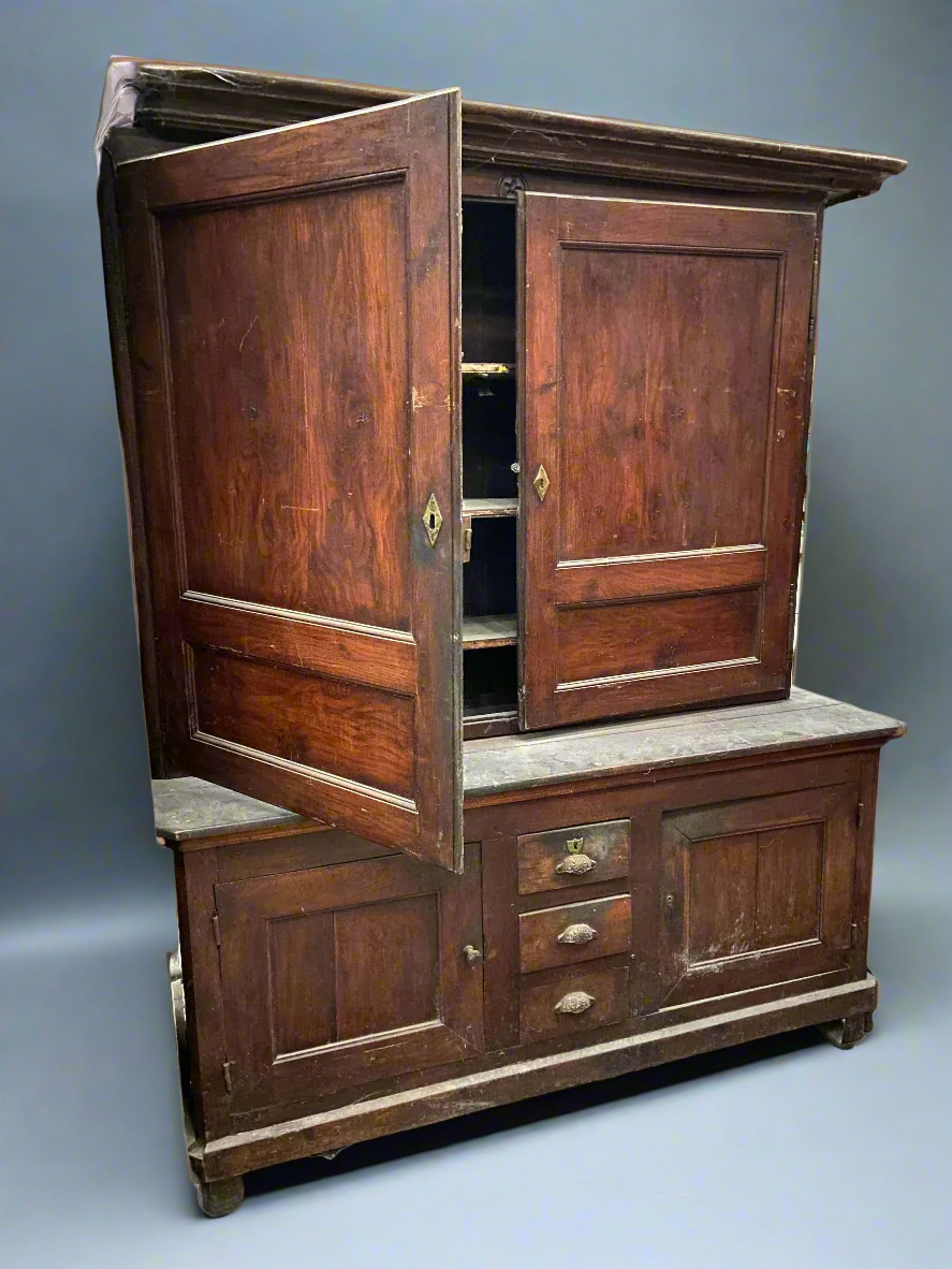 Antique wide housekeeper's cupboard with brass hardware.