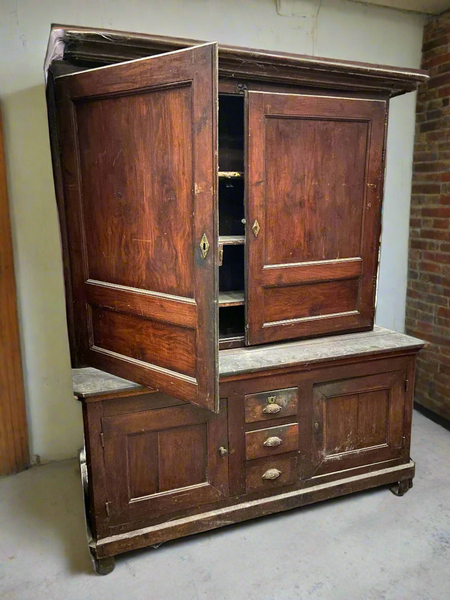 Antique wide housekeeper's cupboard with brass hardware.