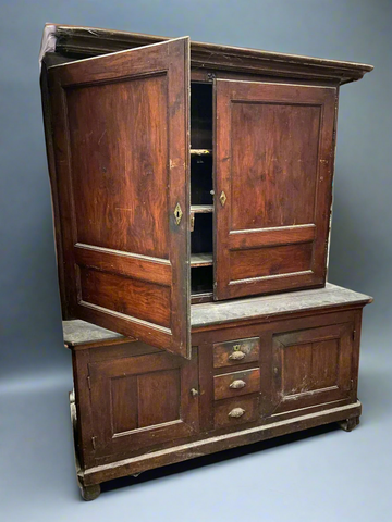 Antique wide housekeeper's cupboard with brass hardware.