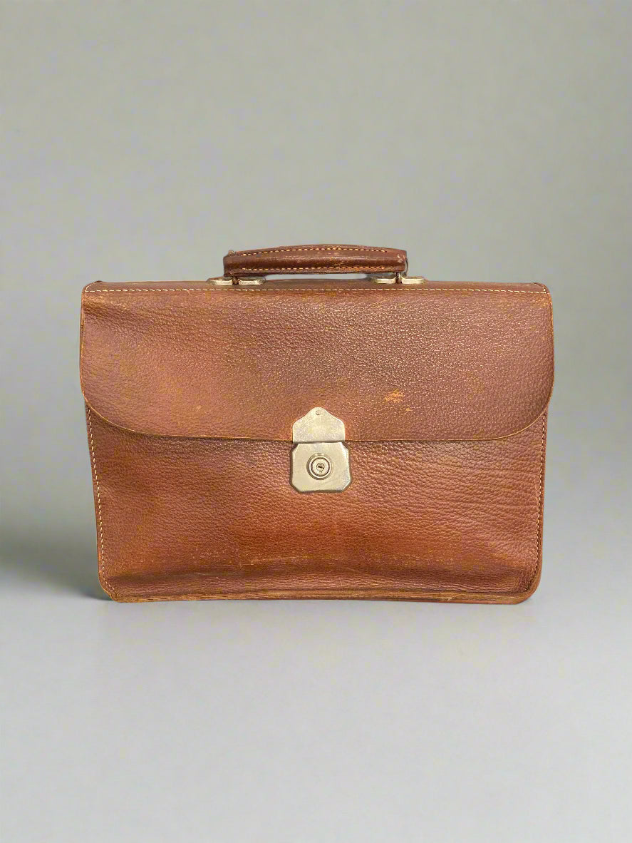 Classic brown leather briefcase bag with a brass lock.