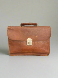 Classic brown leather briefcase bag with a brass lock.