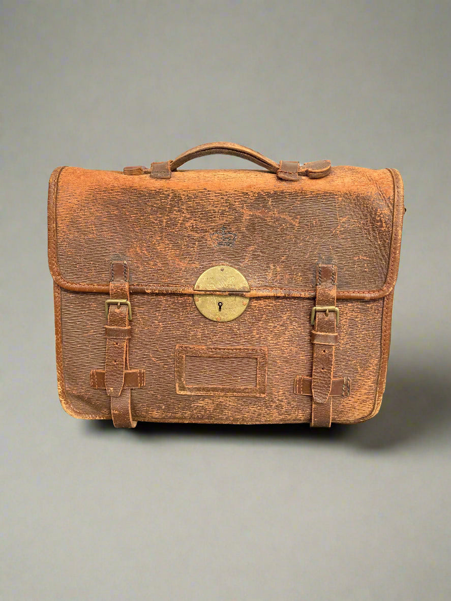 A heavily aged vintage brown leather satchel with a brass lock.
