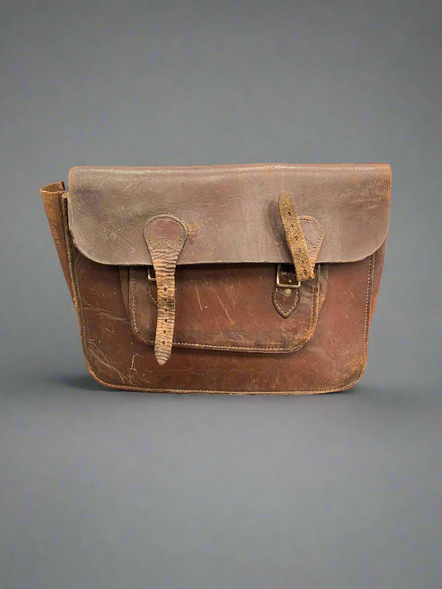 Traditional brown leather satchel in an aged condition.