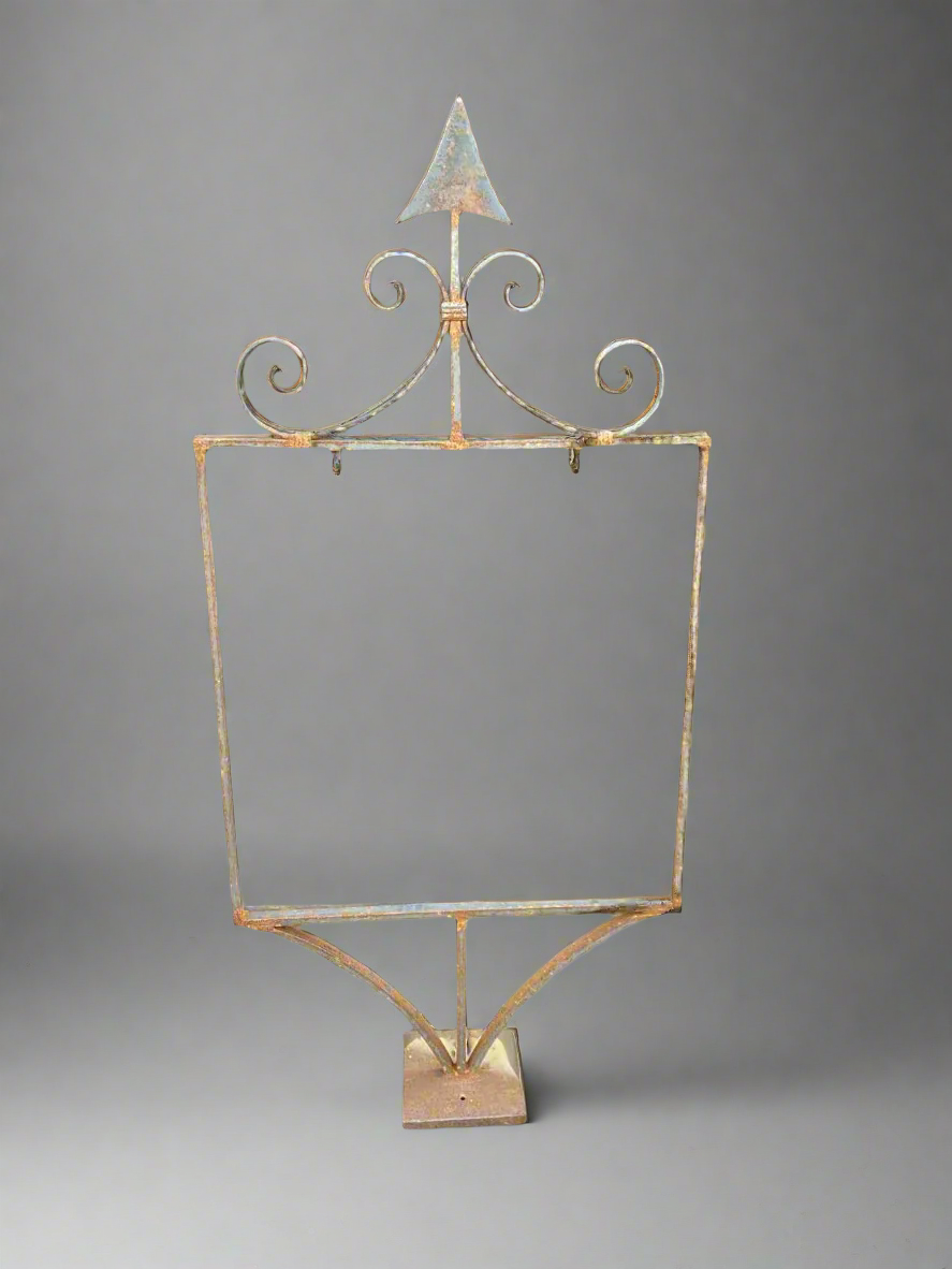 Antique metal frame with a decorative 'arrow head top' to hold a swing sign.