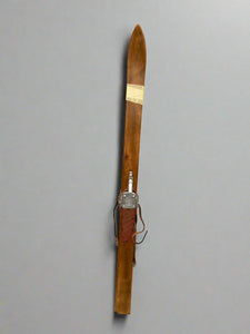 A pair of shorter vintage wooden skis.