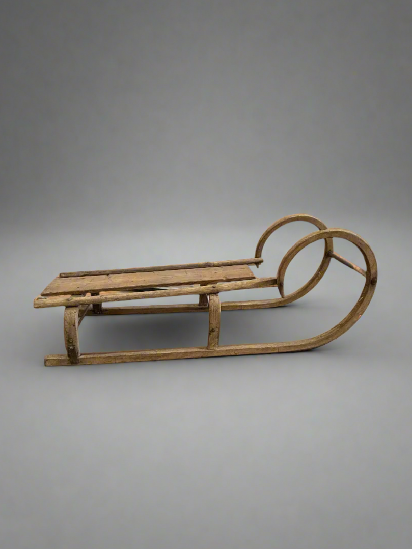 Vintage European-style sledge with a 'ram's horn' curled front, circa 1930s.