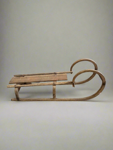 Rustic wooden sledge with a 'ram's horn' curled front, circa 1930s.