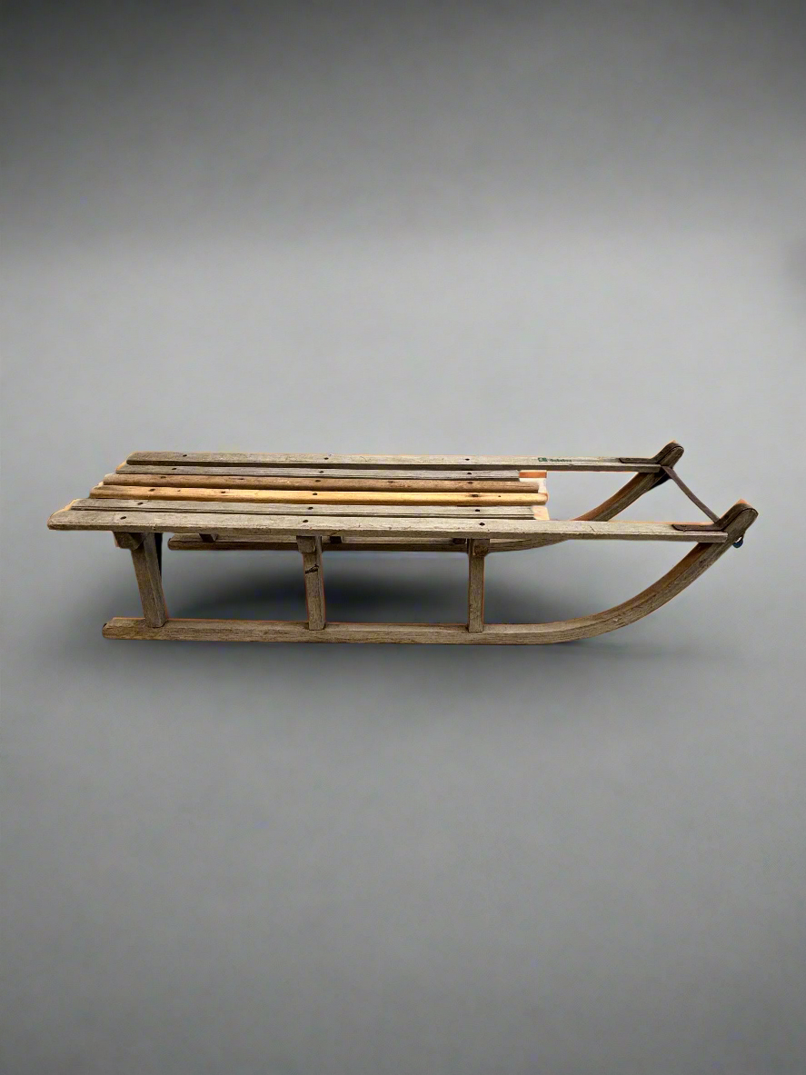 Traditional French-style toboggan sledge with flat wooden slats.