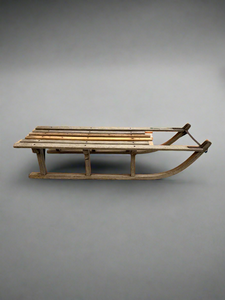 Traditional French-style toboggan sledge with flat wooden slats.