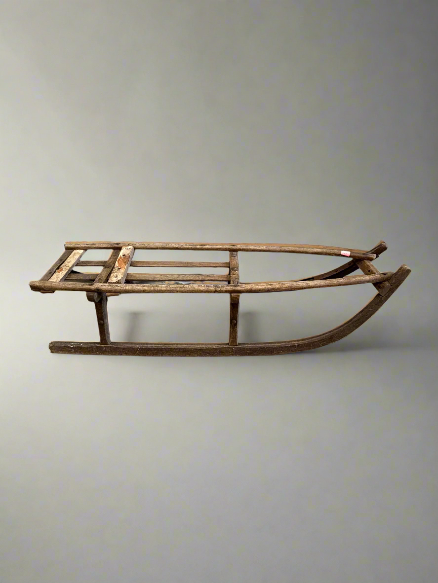 Old primitive wooden sledge, in an aged condition.