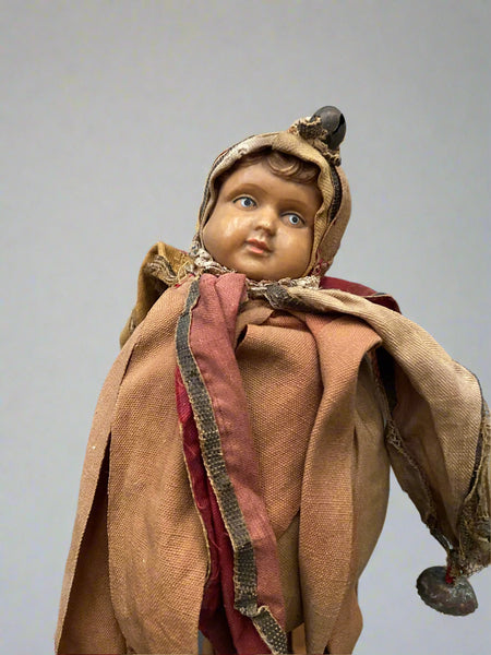 Medieval-style rag jester marotte doll, mounted on a stick with bells.