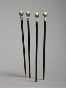 A collection of black walking sticks with silver pommel tops. We have one 'hard' original and four softs (one is not shown in the photograph.)