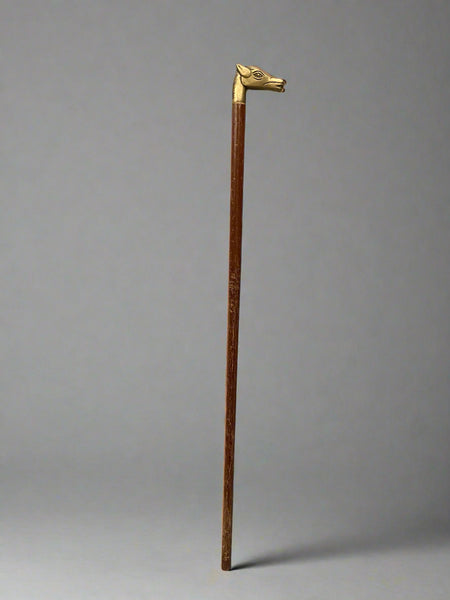 A wooden walking stick with a cast brass horse head handle.