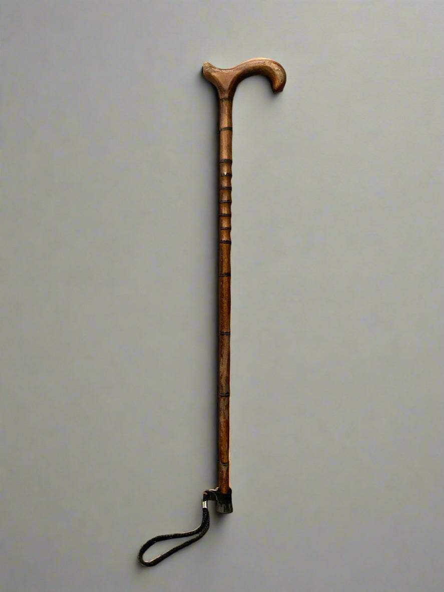 Sturdy hand carved walking stick with a ribbed stick and ergonomic handle.