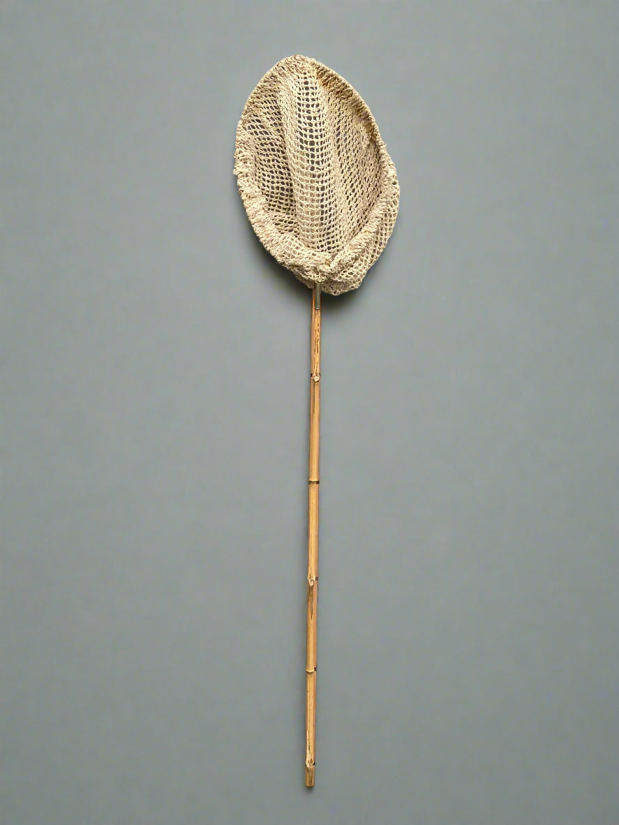 A set of fishing nets with bamboo handles and natural rope nets.