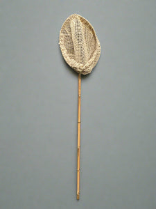 A set of fishing nets with bamboo handles and natural rope nets.
