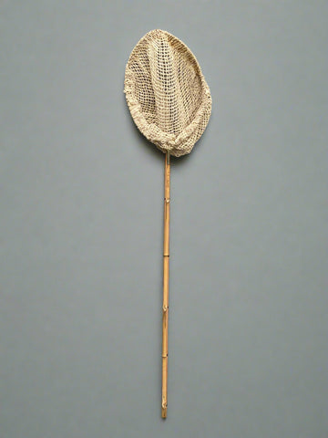 A set of fishing nets with bamboo handles and natural rope nets.