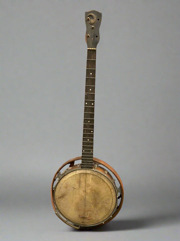 A vintage aged banjo made by The Whirle in Birmingham, UK.