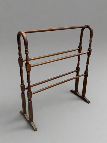Victorian mahogany towel rail with a curved frame, circa 1800s.