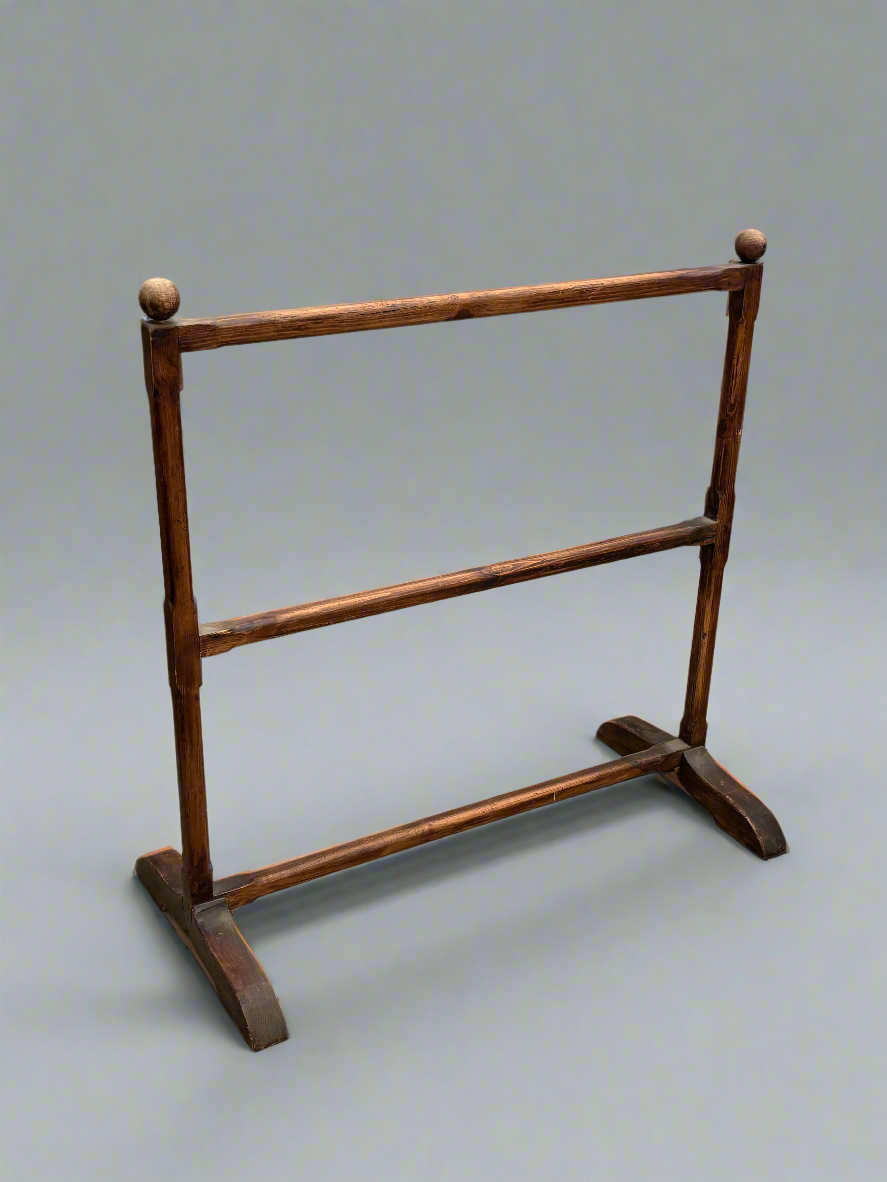 Antique wooden towel rail with a simple design.