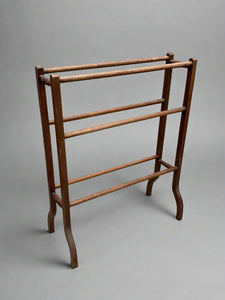 Edwardian wooden towel rail with a boxed frame.