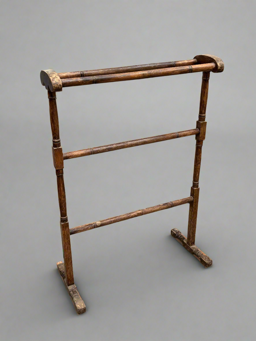 A simple Victorian towel rail with a varnished finish.