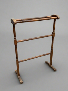 A simple Victorian towel rail with a varnished finish.