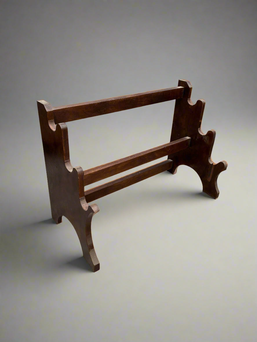 An antique low wooden towel rack.