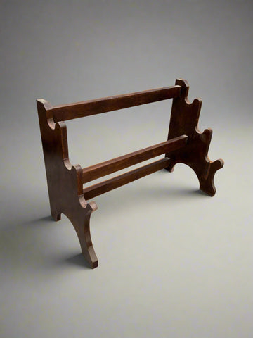 An antique low wooden towel rack.