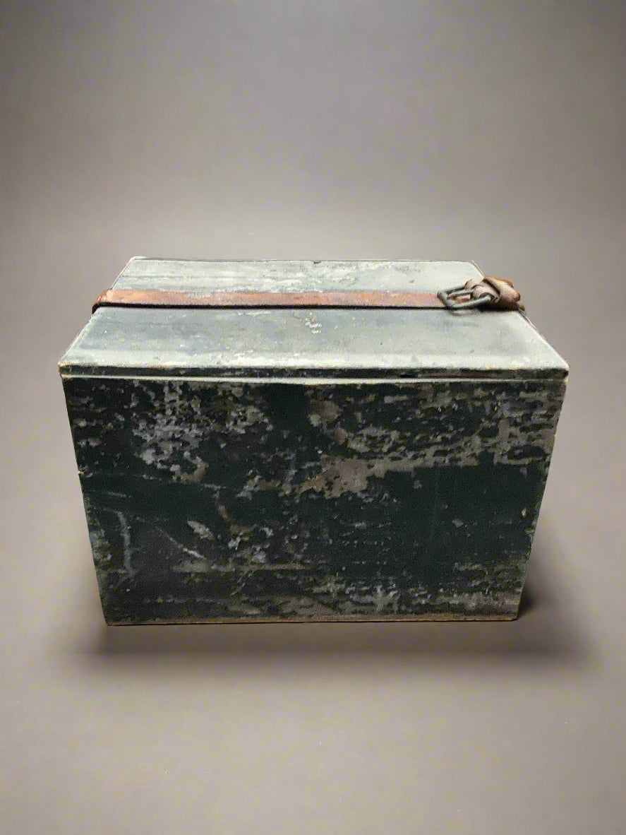 A rustic green box wrapped in a leather belt with a distressed finish.