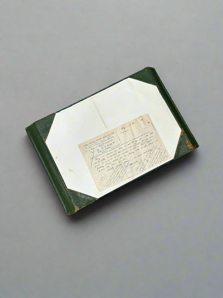 A green leather document holder with a decorative gold embossed border.