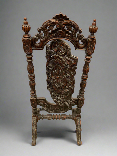 An ornately carved wooden Victorian fire screen, in a gothic revival style. The middle section of the screen pivots on a central bolt.