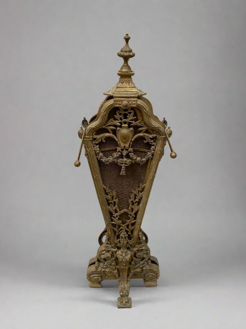 Ornate Victorian brass fire screen with a folding peacock style fan and ornate finial for carrying.