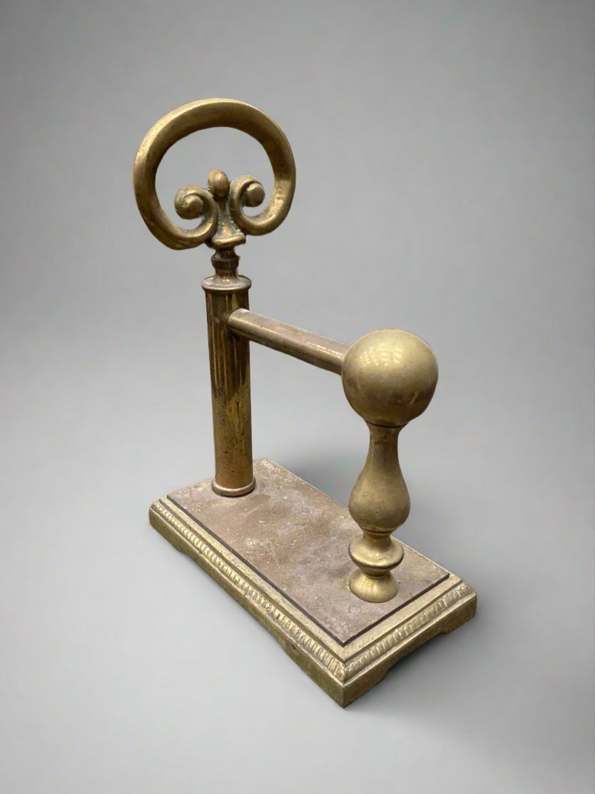 A matching pair of brass fire dog andirons with scroll top detailing.