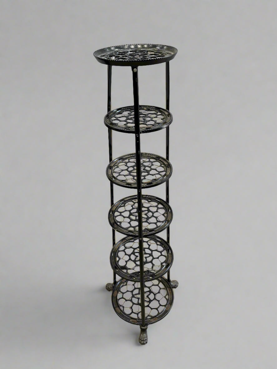 Black cast-iron pot and pan display stand with six tiers.