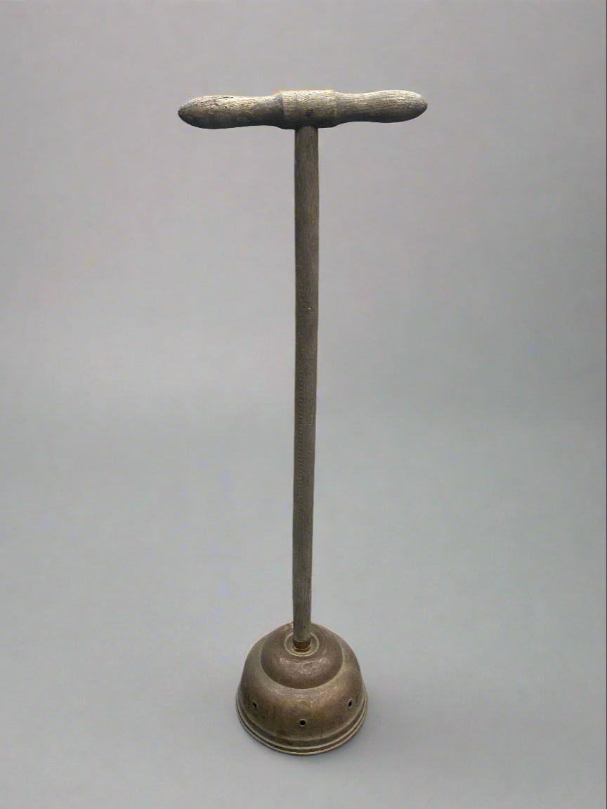 Antique copper posser/ laundry dolly with a horizontal plunging handle.