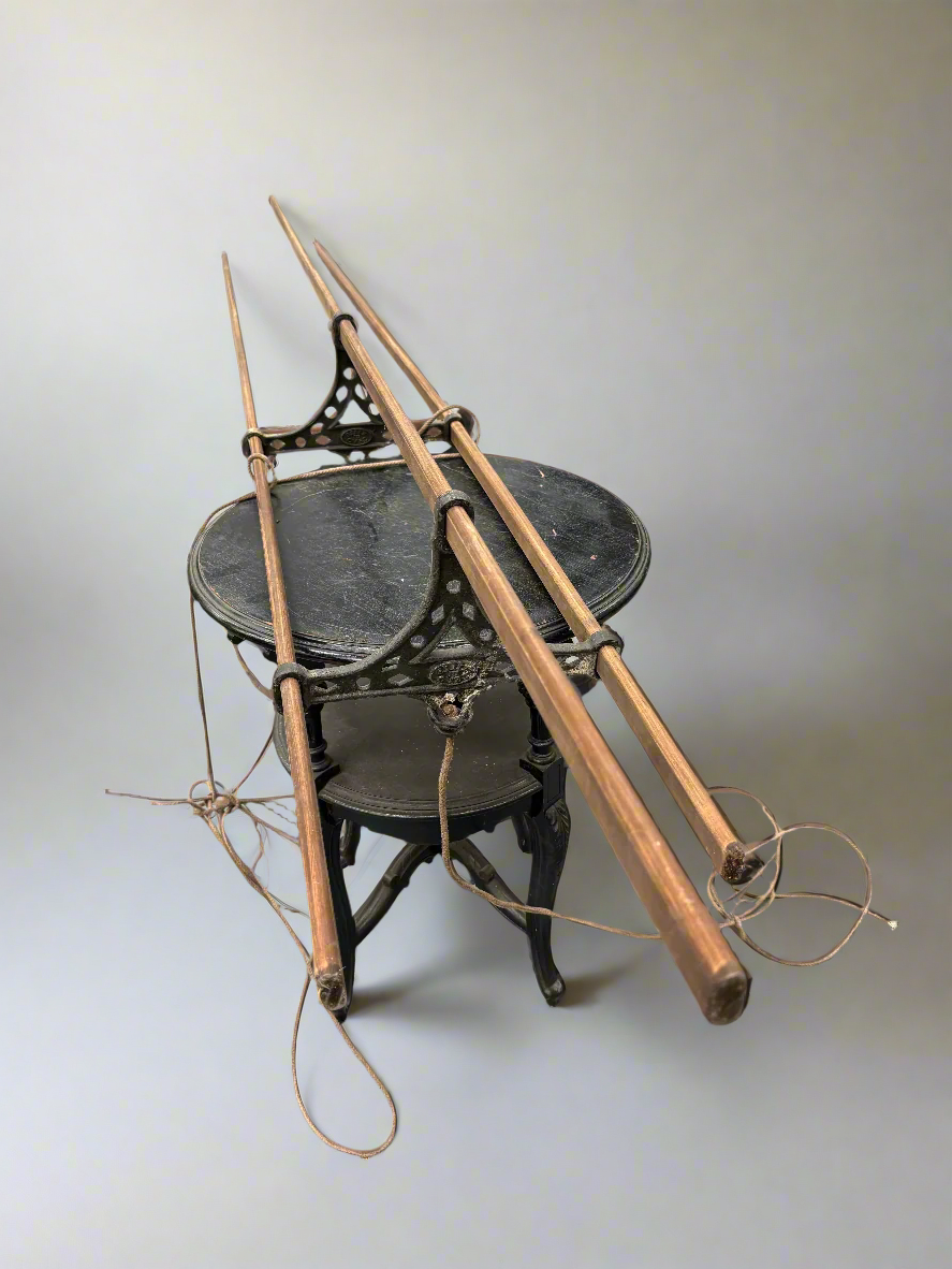 A Victorian hanging clothes airer with three laths, crafted from wood and iron.