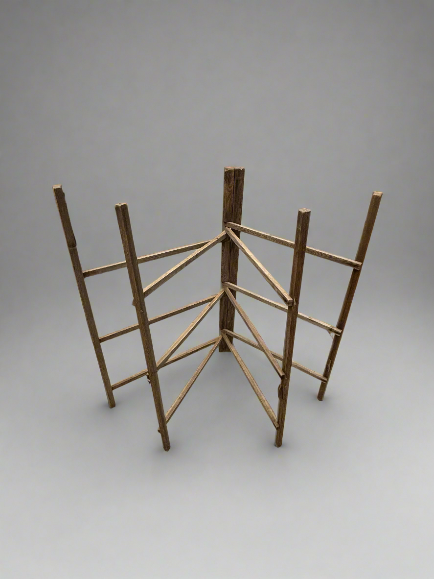 A large, wooden, folding clothes airer with twelve bars.