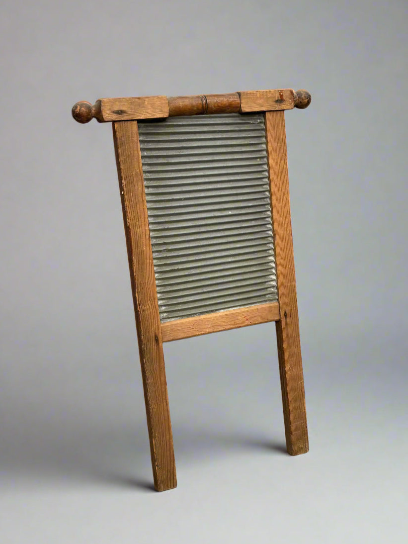 Antique galvanised washboard with a wooden frame, circa 19th century.