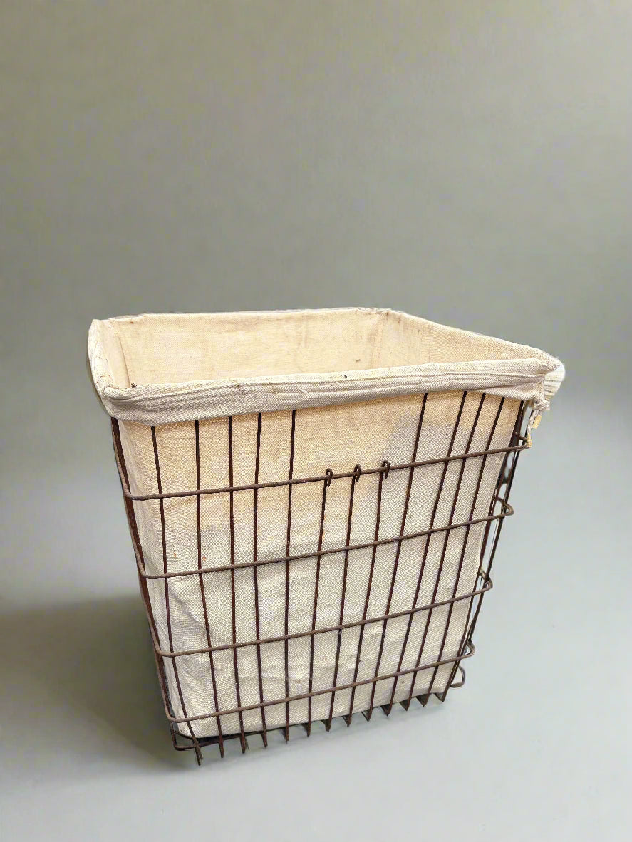 Large industrial-style wire and linen laundry hamper.
