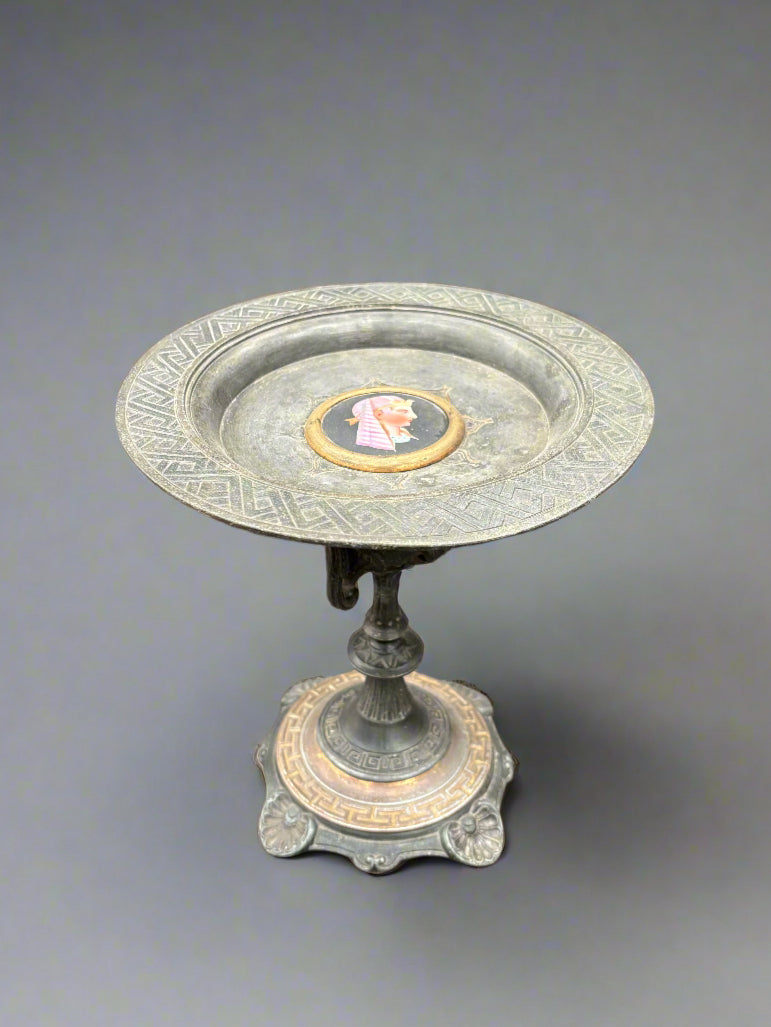 Vintage tazza fruit plate on a tall, ornate metal stand. Circa 1960s and featuring an Egyptian head.