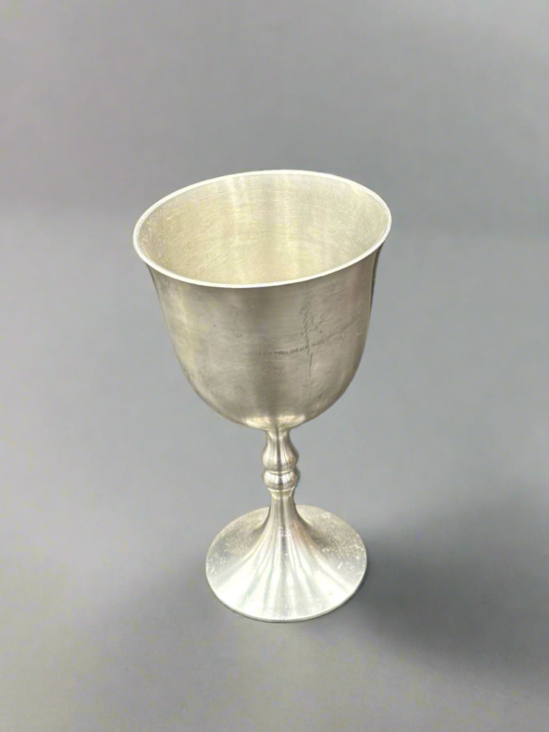 A pewter chalice wine goblet with a shaped stem and flared lip.